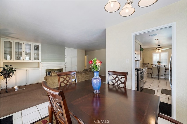 carpeted dining room featuring ceiling fan