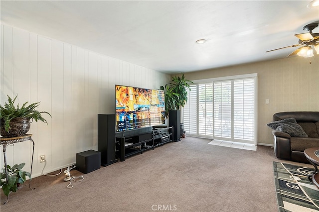 living room featuring carpet and ceiling fan