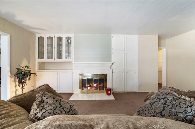 carpeted living room with a fireplace