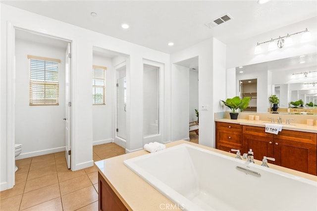 bathroom featuring tile patterned flooring, vanity, and toilet