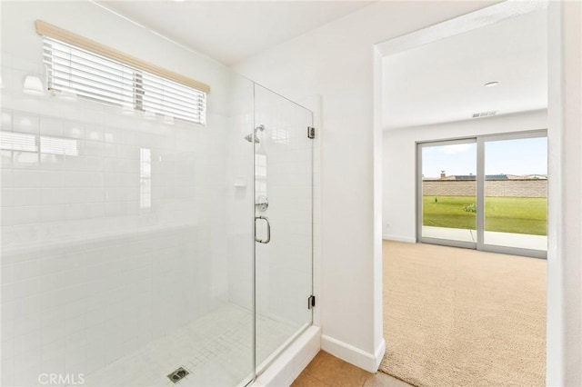 full bath with baseboards, visible vents, a stall shower, and tile patterned flooring