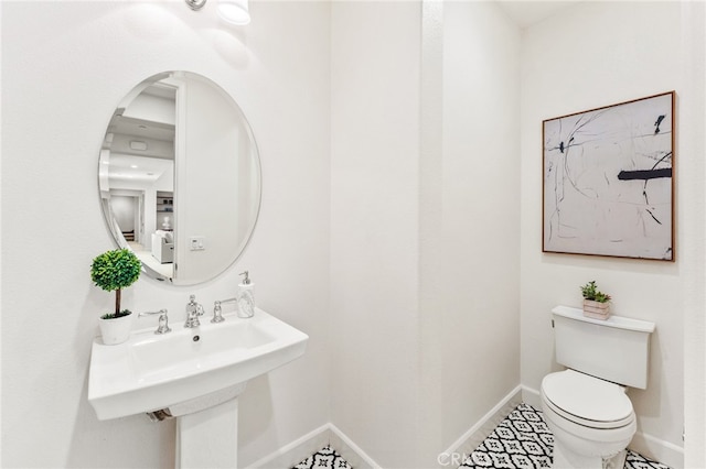 bathroom featuring sink, tile patterned flooring, and toilet