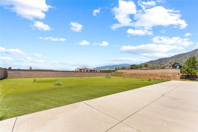 view of yard with a mountain view and a patio area