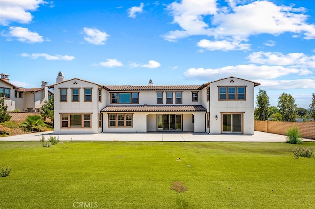 rear view of property with a patio area and a yard