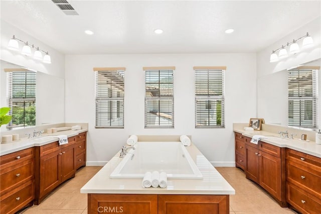 full bathroom featuring tile patterned floors, two vanities, a bath, visible vents, and recessed lighting