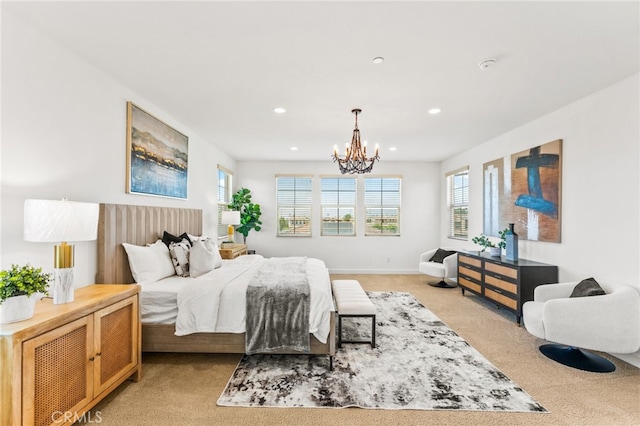 bedroom featuring light colored carpet and a chandelier