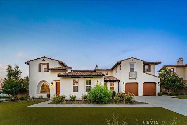 mediterranean / spanish home with a front yard and a garage