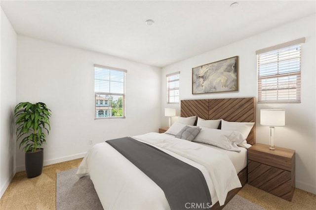 bedroom featuring baseboards and carpet