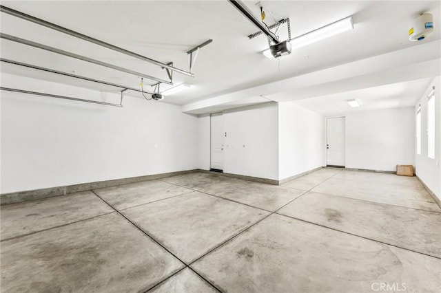 garage with a garage door opener and baseboards