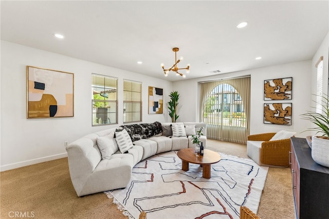 living room with light carpet and a chandelier