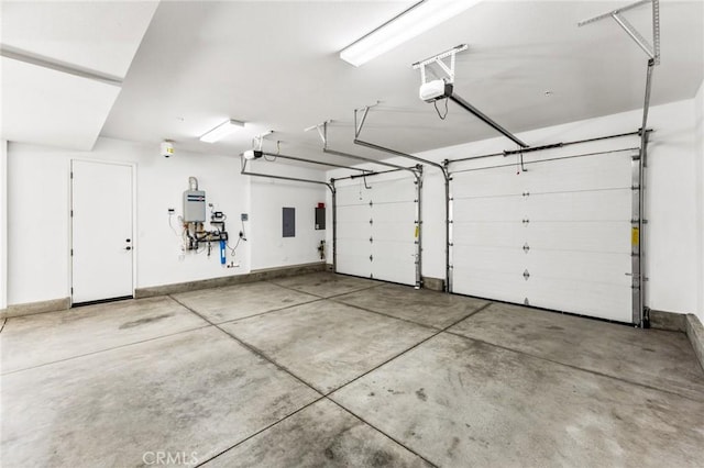 garage with water heater, a garage door opener, and baseboards