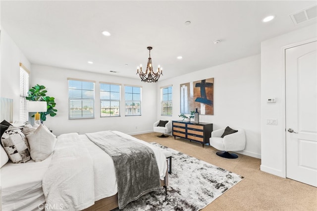 carpeted bedroom with an inviting chandelier