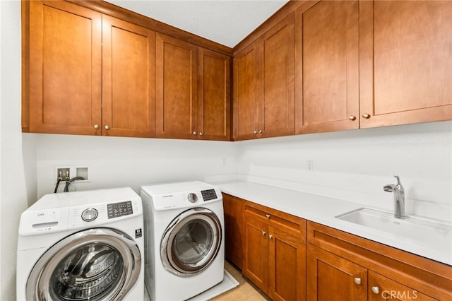 washroom featuring sink, cabinets, and independent washer and dryer