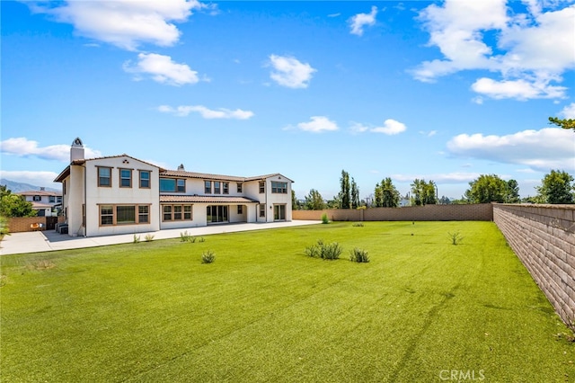 rear view of house featuring a yard