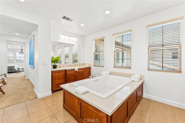 bathroom with vanity, tile patterned floors, a bathtub, and a notable chandelier