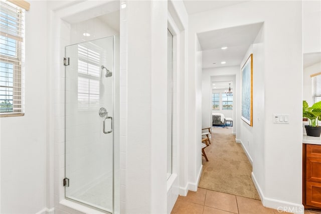 bathroom featuring tile patterned flooring and a shower with shower door