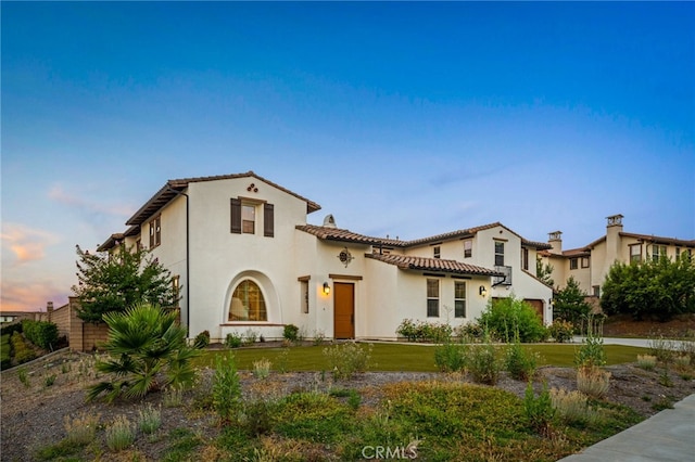 mediterranean / spanish house with a yard