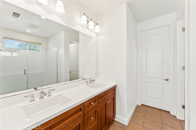 bathroom featuring vanity, tile patterned floors, and walk in shower