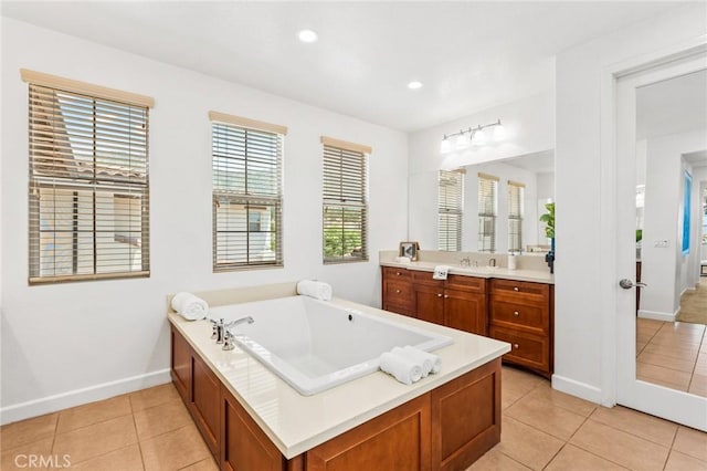 bathroom featuring baseboards, recessed lighting, vanity, a garden tub, and tile patterned flooring