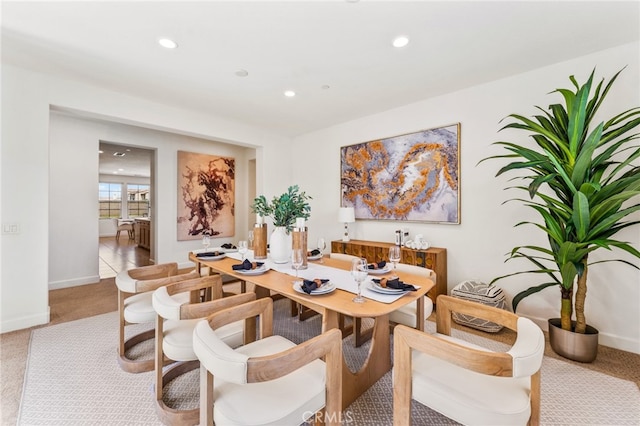 dining area featuring light carpet