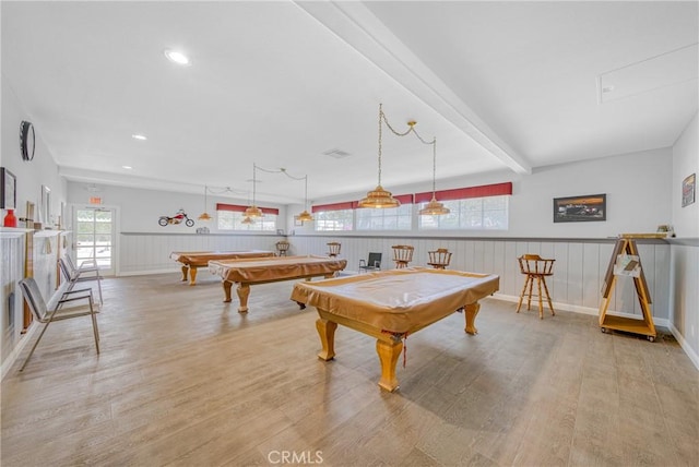 recreation room featuring wainscoting, pool table, beam ceiling, and wood finished floors