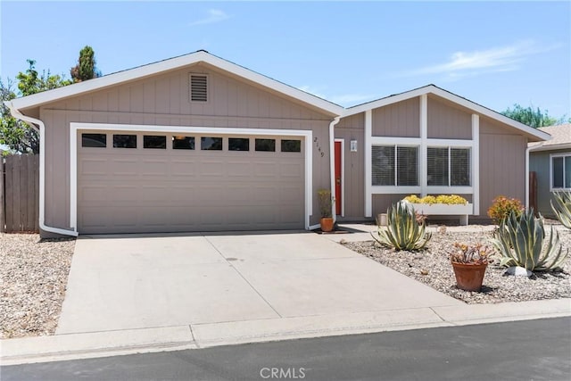 ranch-style house with concrete driveway and an attached garage