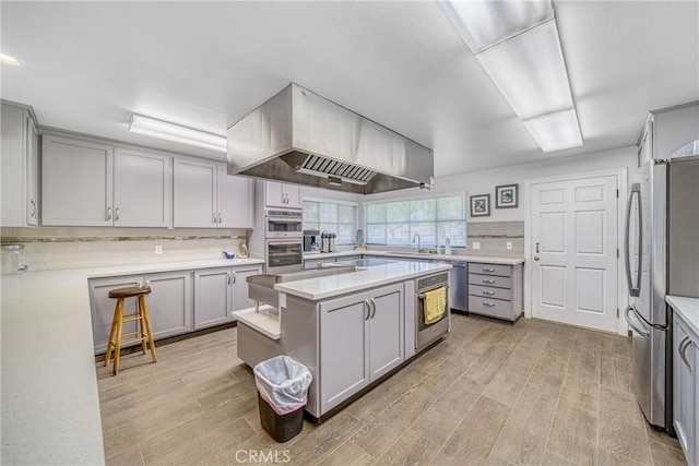 kitchen with light countertops, appliances with stainless steel finishes, and gray cabinets