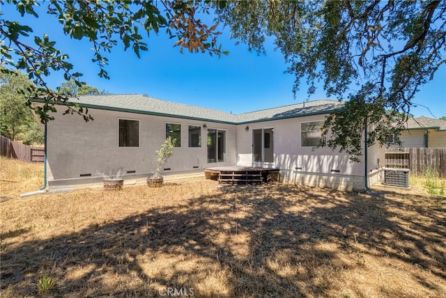 rear view of property with a lawn