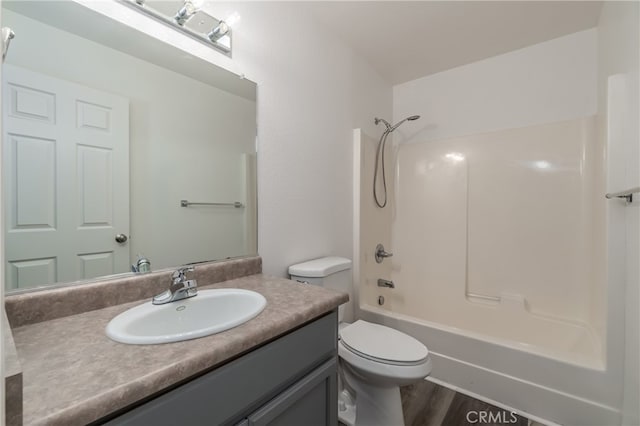 full bathroom featuring vanity, hardwood / wood-style floors, toilet, and shower / washtub combination