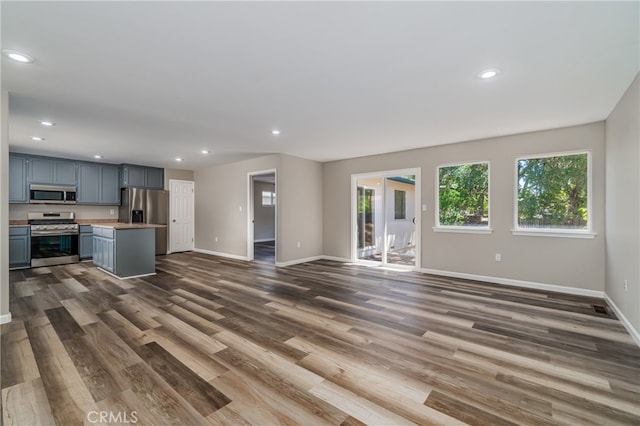 unfurnished living room with dark hardwood / wood-style floors