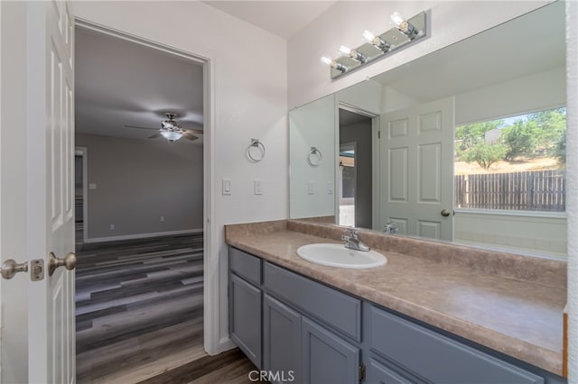 bathroom with wood-type flooring, ceiling fan, and vanity