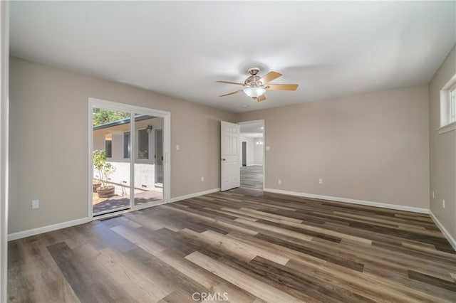 spare room with dark hardwood / wood-style flooring and ceiling fan