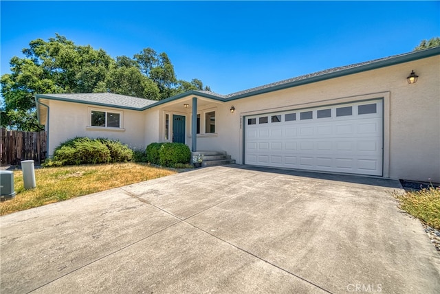 single story home featuring a garage and central AC