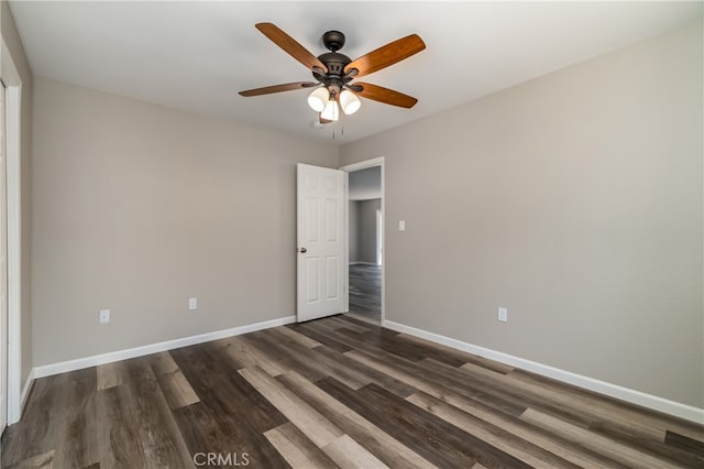 unfurnished room with ceiling fan and dark wood-type flooring