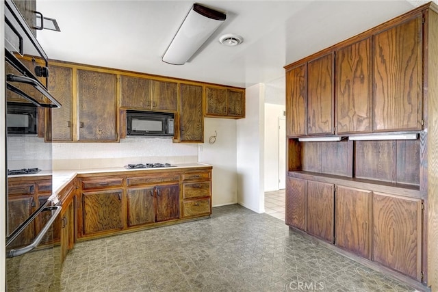 kitchen with decorative backsplash and stainless steel gas cooktop