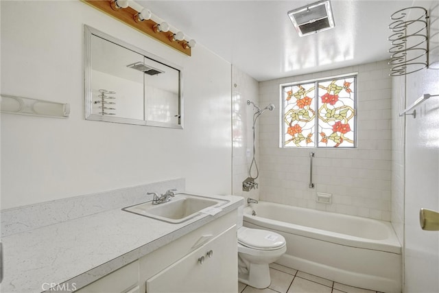 full bathroom with vanity, tile patterned floors, tiled shower / bath, and toilet