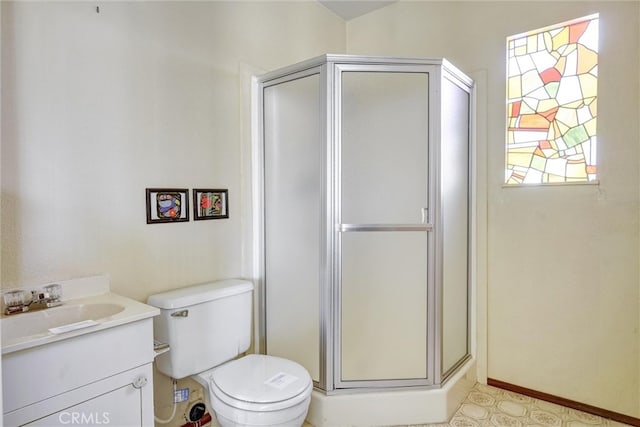 bathroom featuring walk in shower, vanity, and toilet