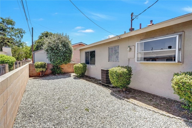 rear view of property with a patio and central AC