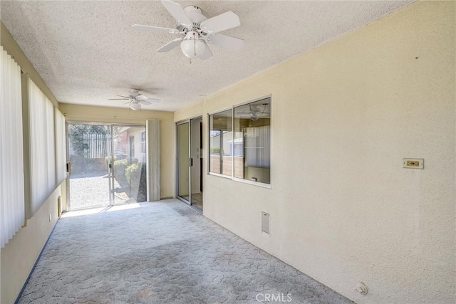 unfurnished sunroom featuring ceiling fan