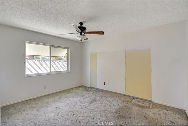 carpeted spare room featuring a textured ceiling and ceiling fan