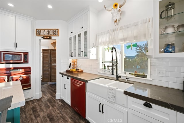 kitchen featuring dark hardwood / wood-style flooring, sink, and white cabinets