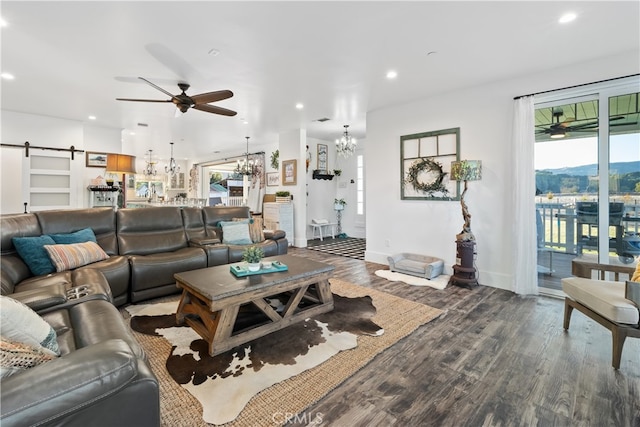 living room featuring hardwood / wood-style flooring, a wealth of natural light, and a barn door