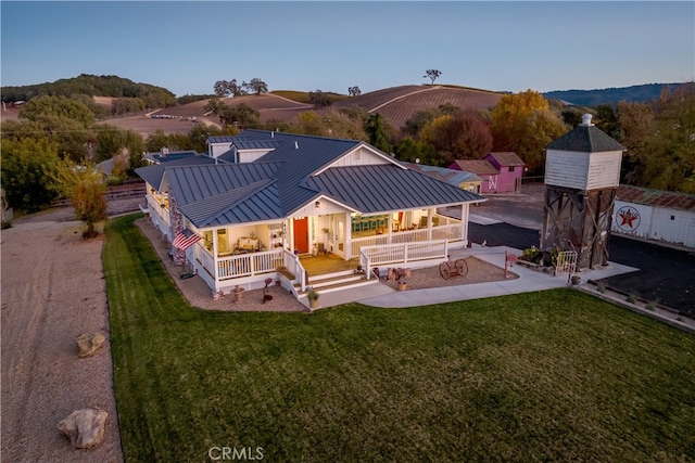 back of property featuring a yard and a mountain view