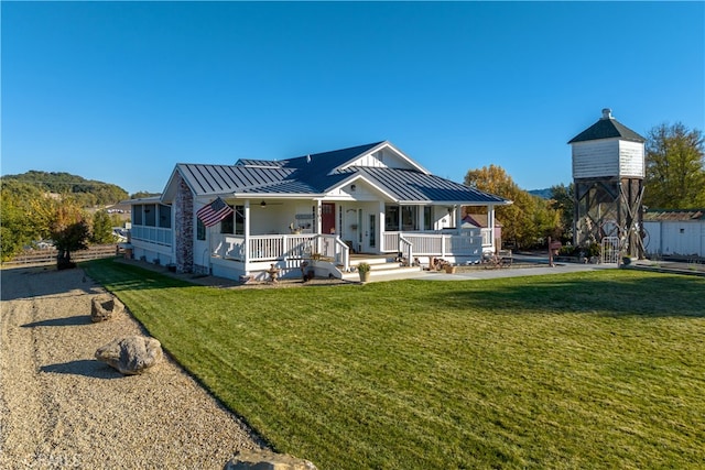 view of front of home with covered porch and a front yard