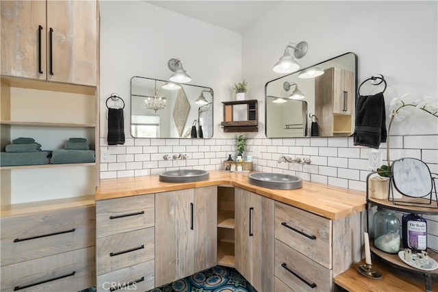 bathroom featuring vanity, a notable chandelier, and decorative backsplash