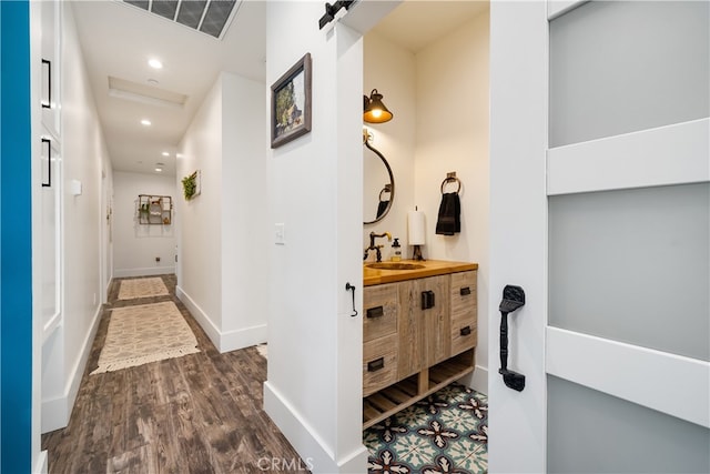 hall featuring sink and dark wood-type flooring