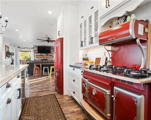 kitchen with high quality fridge, white cabinets, ceiling fan, and dark hardwood / wood-style flooring