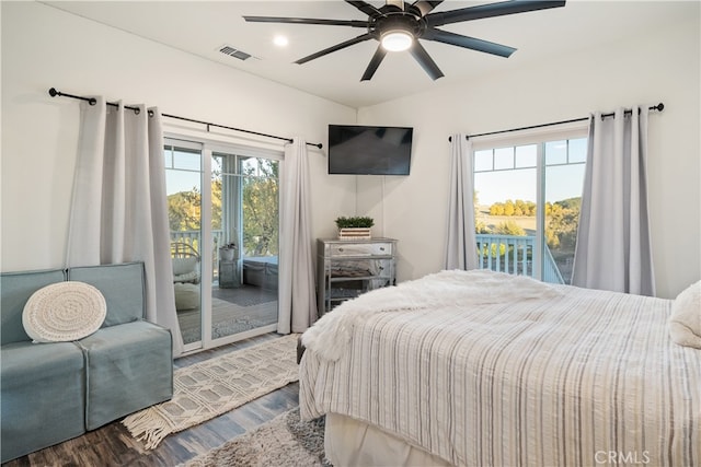 bedroom with access to outside, multiple windows, wood-type flooring, and ceiling fan