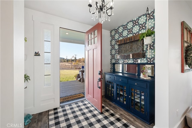 foyer entrance with a chandelier and dark hardwood / wood-style flooring