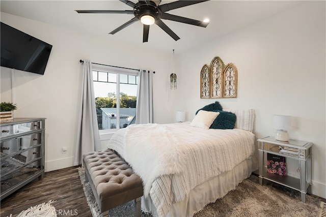 bedroom with dark hardwood / wood-style floors and ceiling fan